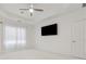 Bedroom featuring a tray ceiling, fan, and a mounted television at 1680 Bluestone Dr, Cumming, GA 30041