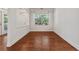 Bright dining room with hardwood floors, a large window, and access to an outdoor balcony at 1680 Bluestone Dr, Cumming, GA 30041