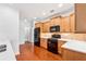 Modern kitchen with stainless steel appliances, quartz countertops, and wooden cabinetry at 1680 Bluestone Dr, Cumming, GA 30041