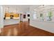 Inviting living space with hardwood floors, an open kitchen, and a cozy fireplace at 1680 Bluestone Dr, Cumming, GA 30041