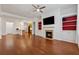 Open-concept living space with hardwood floors, fireplace, and seamless flow to the kitchen at 1680 Bluestone Dr, Cumming, GA 30041