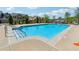 Community pool with clear blue water, stairs and safety equipment at 1680 Bluestone Dr, Cumming, GA 30041