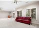Basement living area with carpeted floors, natural lighting, and a comfortable atmosphere at 2321 Edgemere Lake Cir, Marietta, GA 30062