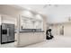 Basement bar area with modern appliances and counter space, next to a seating area and exercise area at 2321 Edgemere Lake Cir, Marietta, GA 30062
