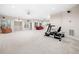 Expansive finished basement with exercise equipment, plush carpeting, and ample lighting at 2321 Edgemere Lake Cir, Marietta, GA 30062