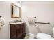 Powder bath featuring a decorative mirror, granite counters, and wood cabinets at 2321 Edgemere Lake Cir, Marietta, GA 30062