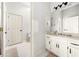 Bathroom featuring white cabinets, sink, and toilet at 2321 Edgemere Lake Cir, Marietta, GA 30062