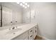 Bathroom featuring white cabinets, a large mirror, and vanity lighting at 2321 Edgemere Lake Cir, Marietta, GA 30062