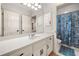 Bright bathroom featuring a white vanity with drawers and cabinets, a mirror, and a seashell themed shower curtain at 2321 Edgemere Lake Cir, Marietta, GA 30062