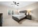 Cozy bedroom with a ceiling fan, a window, and a neatly made bed with matching nightstands at 2321 Edgemere Lake Cir, Marietta, GA 30062