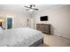 Bedroom featuring a dresser with a television, carpeted floors and access to another room at 2321 Edgemere Lake Cir, Marietta, GA 30062