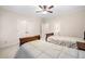 Bedroom featuring two beds, ceiling fan, neutral carpet and paint at 2321 Edgemere Lake Cir, Marietta, GA 30062