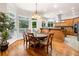 Bright breakfast nook with large windows, hardwood floors, and a modern chandelier at 2321 Edgemere Lake Cir, Marietta, GA 30062