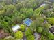 Bird's eye view of tennis courts, swimming pool, lake and lush, mature trees at 2321 Edgemere Lake Cir, Marietta, GA 30062