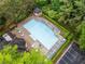 Aerial view of a sparkling community pool with lounge chairs and surrounding greenery at 2321 Edgemere Lake Cir, Marietta, GA 30062