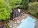 Overhead view of a community pool with tables, lounge chairs, and a brick building at 2321 Edgemere Lake Cir, Marietta, GA 30062