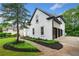 Elegant home with a manicured walkway, pristine landscaping, and a spacious three car garage at 2321 Edgemere Lake Cir, Marietta, GA 30062