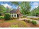 Brick clubhouse with manicured landscaping and a lush green lawn at 2321 Edgemere Lake Cir, Marietta, GA 30062