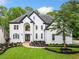 Stunning two-story home featuring a white exterior, dark roof accents, and beautifully landscaped front yard at 2321 Edgemere Lake Cir, Marietta, GA 30062