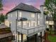 Home's rear elevation featuring a white deck and patio on the lower level at 2321 Edgemere Lake Cir, Marietta, GA 30062