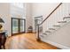 Bright foyer with hardwood floors, a staircase, and decorative glass front doors at 2321 Edgemere Lake Cir, Marietta, GA 30062