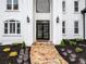 Close-up of the home's entrance featuring a stone pathway, decorative plantings, and an elegant front door at 2321 Edgemere Lake Cir, Marietta, GA 30062