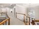 Second-floor hallway with elegant chandelier and staircase to the main level at 2321 Edgemere Lake Cir, Marietta, GA 30062