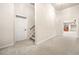Carpeted hallway with staircase and doorway to another room at 2321 Edgemere Lake Cir, Marietta, GA 30062