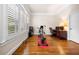 Bright workout room featuring wood floors, plantation shutters, and exercise equipment at 2321 Edgemere Lake Cir, Marietta, GA 30062