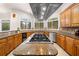 Gourmet kitchen boasts custom cabinets, granite countertops, modern stainless steel appliances, and a central island at 2321 Edgemere Lake Cir, Marietta, GA 30062
