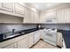 Traditional kitchen featuring white cabinets, stainless steel sink, and appliances at 2321 Edgemere Lake Cir, Marietta, GA 30062