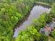 Aerial photograph of lake surrounded by lush trees and homes at 2321 Edgemere Lake Cir, Marietta, GA 30062