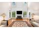 Bright living room with fireplace, hardwood floors, area rug and abundant natural light at 2321 Edgemere Lake Cir, Marietta, GA 30062