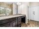 Main bathroom featuring double sink vanity with granite countertops and large framed mirror at 2321 Edgemere Lake Cir, Marietta, GA 30062