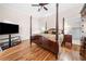 Traditional main bedroom with a four poster bed, tv, and hardwood flooring at 2321 Edgemere Lake Cir, Marietta, GA 30062