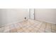 Empty room with tile flooring and a closed white door at 2321 Edgemere Lake Cir, Marietta, GA 30062