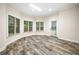 Sunroom filled with natural light, decorative floors, and an exterior door to backyard at 2321 Edgemere Lake Cir, Marietta, GA 30062