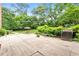 Expansive backyard featuring a concrete patio, outdoor furniture, lush greenery, and manicured lawn at 2965 Pharr Court South Nw # 718, Atlanta, GA 30305