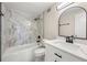 Modern bathroom with marble-look tile, white vanity with countertop, bathtub, and black fixtures at 2965 Pharr Court South Nw # 718, Atlanta, GA 30305