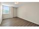 Bright bedroom features wood-look flooring and neutral paint, with a large window for natural light at 2965 Pharr Court South Nw # 718, Atlanta, GA 30305