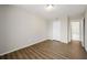Inviting bedroom with wood-look flooring, neutral paint, and door to bathroom at 2965 Pharr Court South Nw # 718, Atlanta, GA 30305