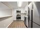 Modern kitchen features stainless steel appliances, white cabinets, and a breakfast bar at 2965 Pharr Court South Nw # 718, Atlanta, GA 30305