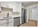 Updated kitchen with stainless steel appliances, sleek white cabinets, and modern countertops at 2965 Pharr Court South Nw # 718, Atlanta, GA 30305