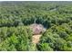 Estate nestled among trees, featuring a pool and long driveway at 320 Riverbend Dr, Mcdonough, GA 30252