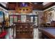 Entertainment basement with a custom-built bar, pool table, and cozy fireplace for relaxed gatherings at 320 Riverbend Dr, Mcdonough, GA 30252