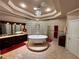 Bright bathroom featuring a stand alone tub with gold feet, large vanity, and glass brick window at 320 Riverbend Dr, Mcdonough, GA 30252