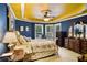 Inviting bedroom with unique yellow ceilings, complemented by elegant furnishings and natural light at 320 Riverbend Dr, Mcdonough, GA 30252