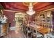 Elegant dining room featuring a decorative chandelier, ornate furniture, and rich, dark-toned walls at 320 Riverbend Dr, Mcdonough, GA 30252
