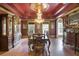 Ornate dining room boasts a decorative chandelier, hardwood floors, and classic furnishings for elegant dinners at 320 Riverbend Dr, Mcdonough, GA 30252