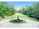 Long driveway leading to the house, bordered by lush greenery and featuring a horse statue at 320 Riverbend Dr, Mcdonough, GA 30252